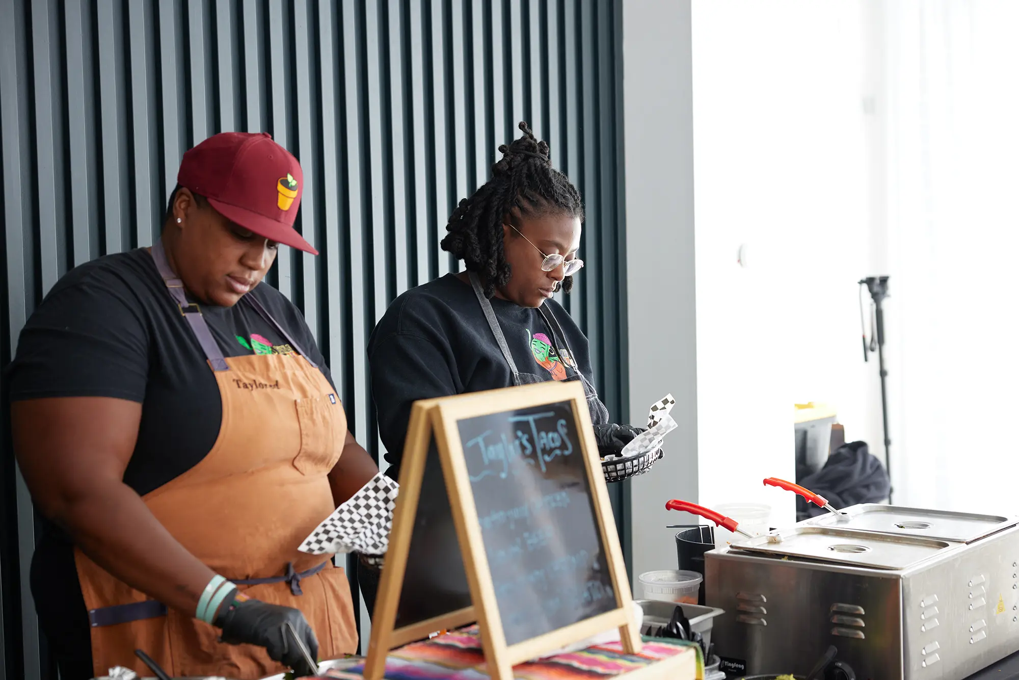 Taylor's Tacos Chicago staff preparing taco orders behind the service bar