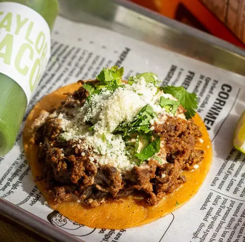 Taylor's Tacos Chicago birria taco topped with cotija cheese